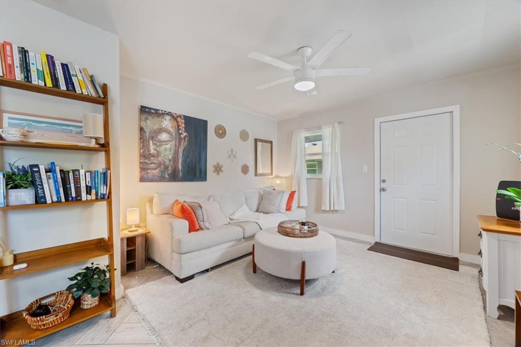3365-3367 Estey Avenue Naples, FL 34104 - Photo 6 of 30 a living room with furniture and a book shelf