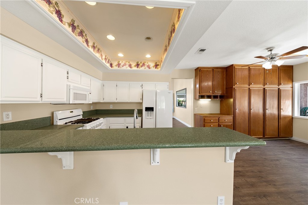 22678 Weatherly Court Wildomar, CA 92595 - Photo 14 of 54 Open Kitchen With Breakfast Bar Seating And Ample Counter Space