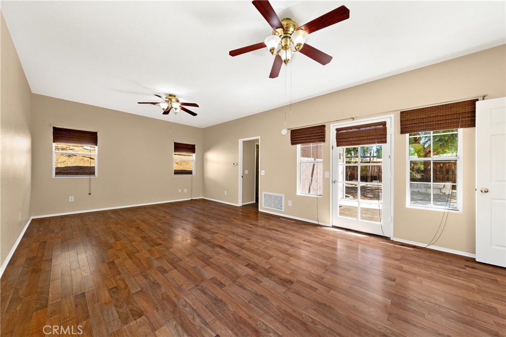 22678 Weatherly Court Wildomar, CA 92595 - Photo 19 of 54 Downstairs Primary Bedroom With Ample Natural Light And Outdoor Access