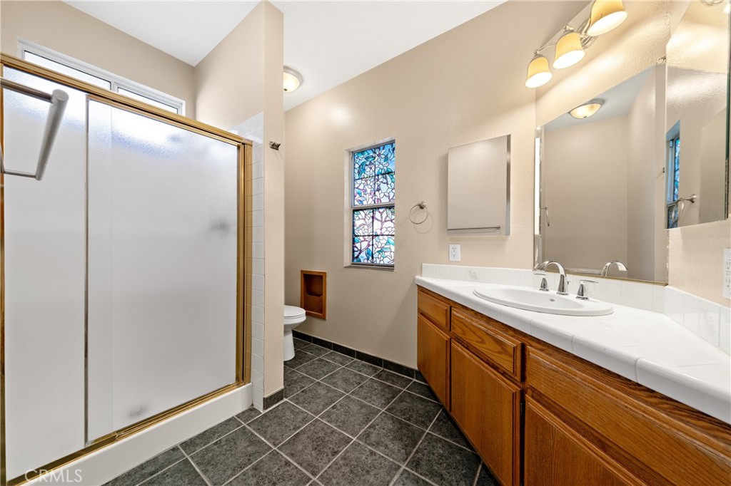 22678 Weatherly Court Wildomar, CA 92595 - Photo 20 of 54 Downstairs Primary Bathroom With Dual Sinks, Large Vanity, And Walk-In Shower