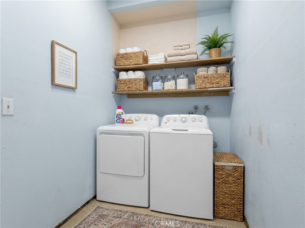 22678 Weatherly Court Wildomar, CA 92595 - Photo 47 of 54 Indoor Laundry Area With Storage Shelving And Washer And Dryer - Digitally Staged