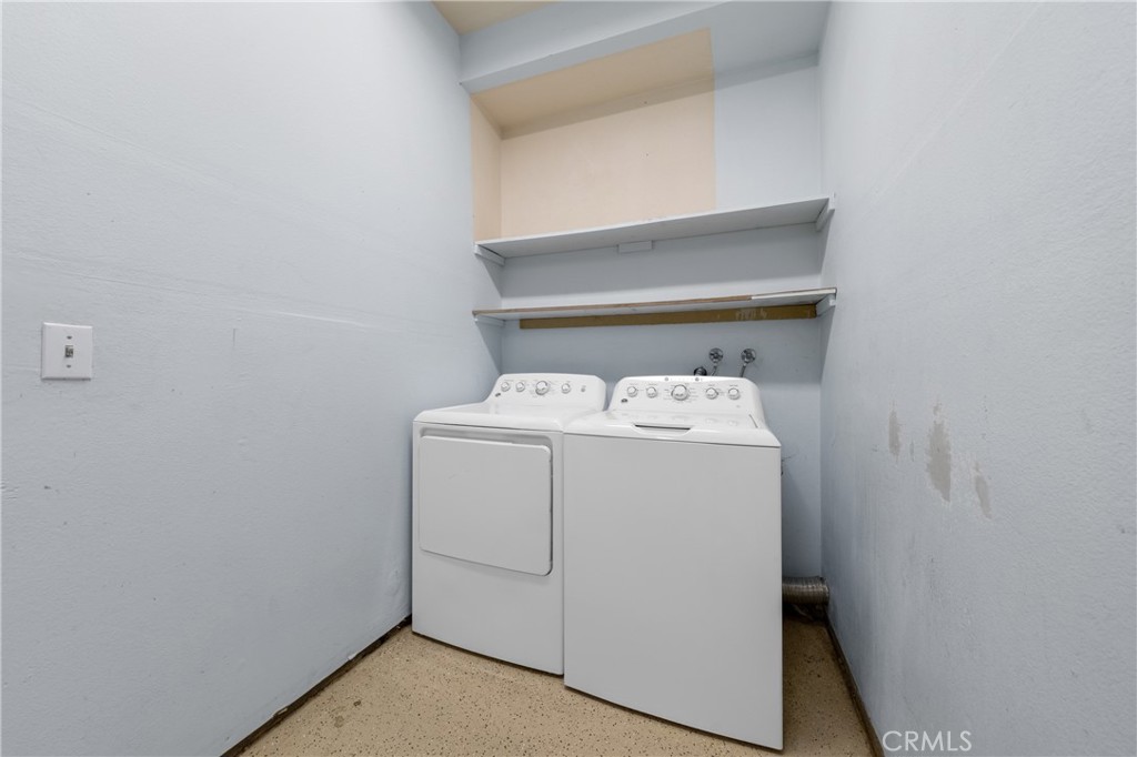 22678 Weatherly Court Wildomar, CA 92595 - Photo 48 of 54 Indoor Laundry Area With Storage Shelving And Washer And Dryer