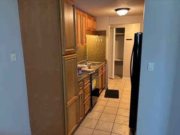 a kitchen with stainless steel appliances granite countertop a refrigerator and a stove