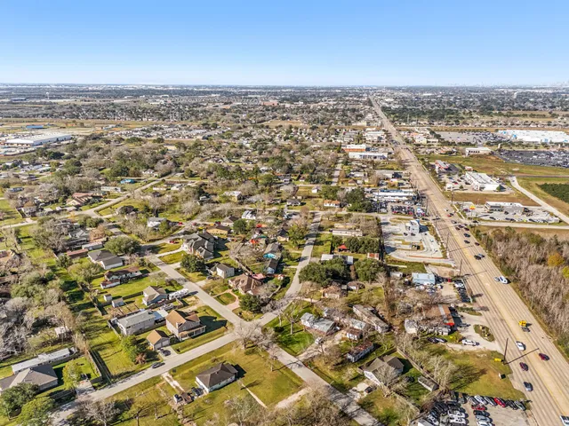 a green field with lots of trees