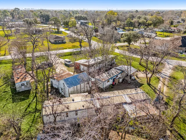 an aerial view of residential houses with outdoor space