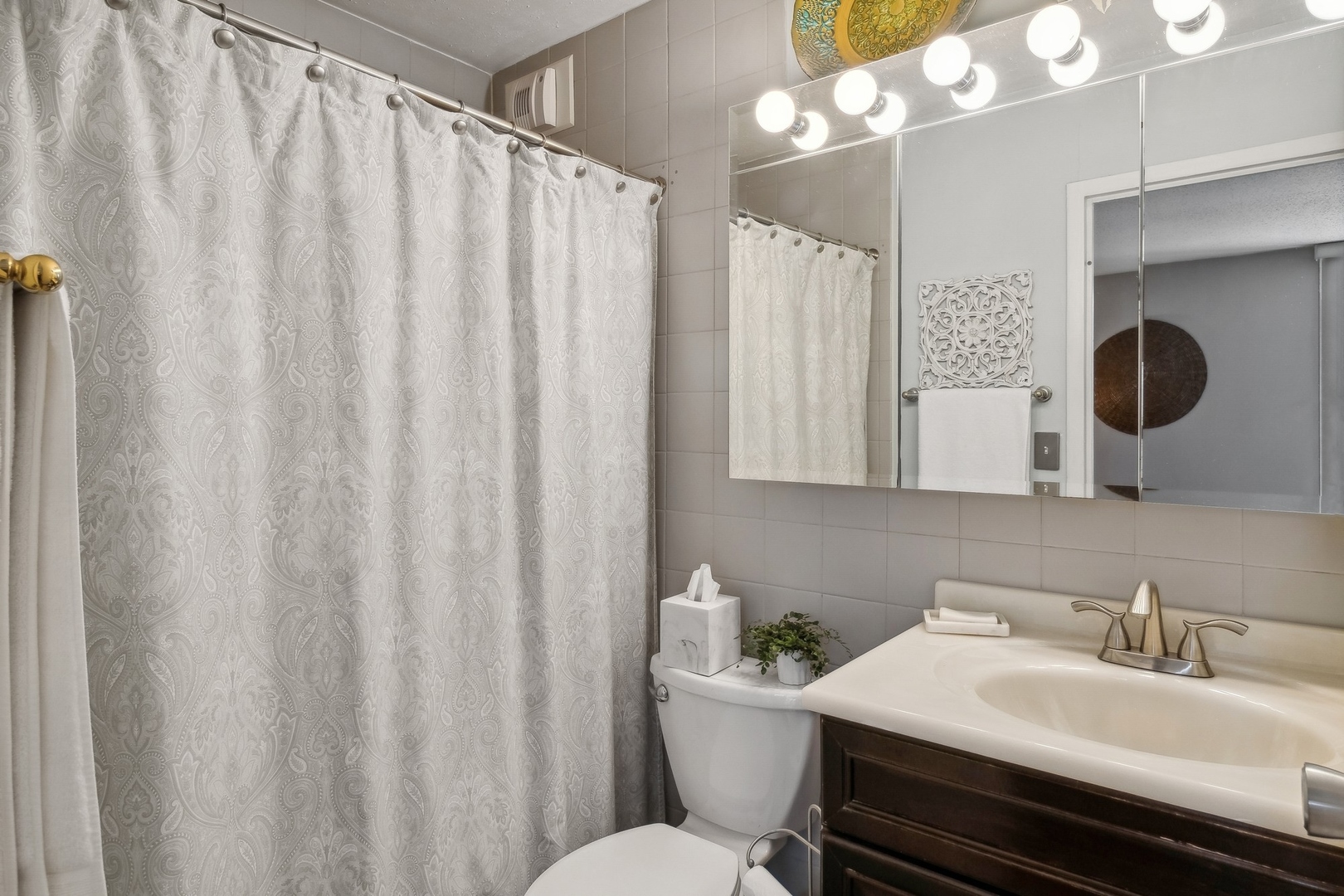 71 East Division Street, Unit 906 Chicago, IL 60611 - Photo 12 of 20 a bathroom with a sink vanity mirror and toilet