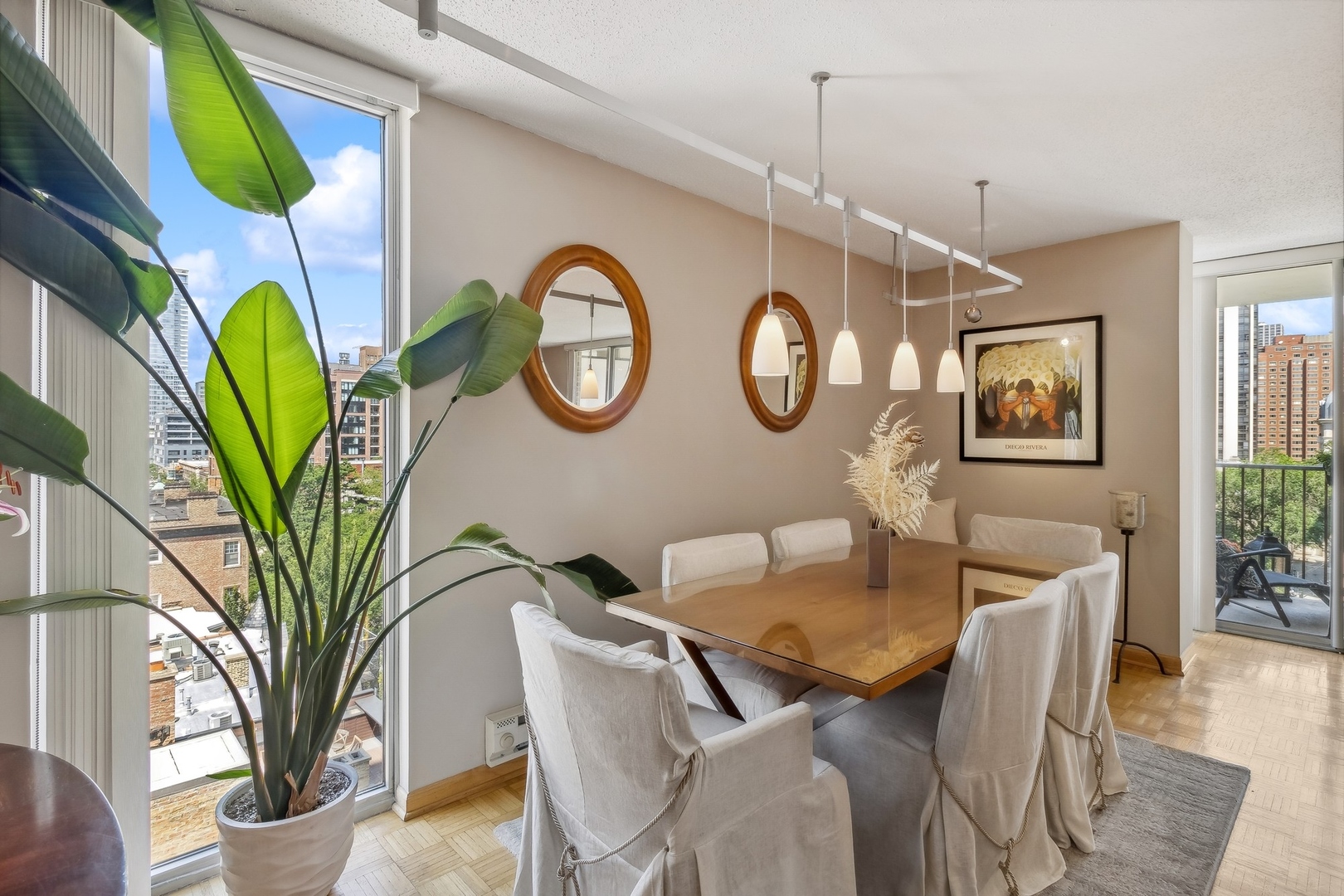 71 East Division Street, Unit 906 Chicago, IL 60611 - Photo 5 of 20 a view of a dining room with furniture and a chandelier