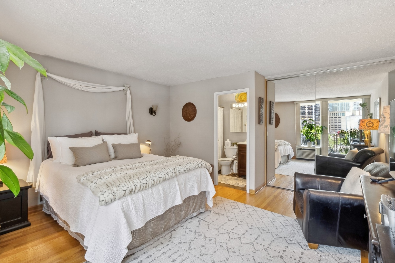 71 East Division Street, Unit 906 Chicago, IL 60611 - Photo 9 of 20 a bedroom with a large bed and a couch