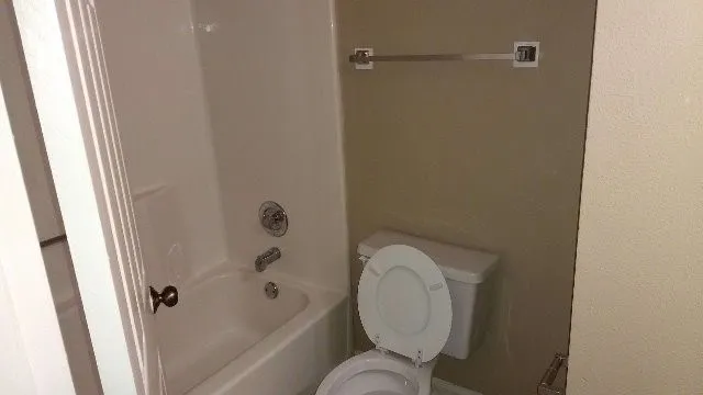 a bathroom with a toilet and shower