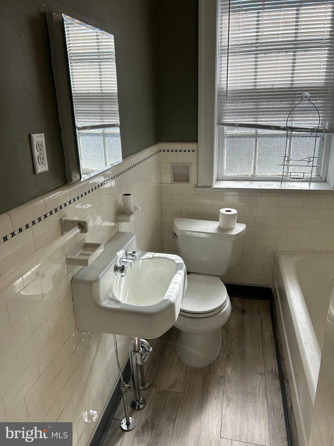 265 Moore Street, Unit 2 Princeton, NJ 08540 - Photo 6 of 7 a bathroom with a sink a toilet and mirror