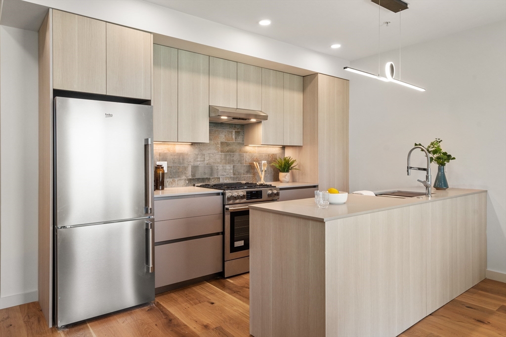 a kitchen with stainless steel appliances a refrigerator and a sink