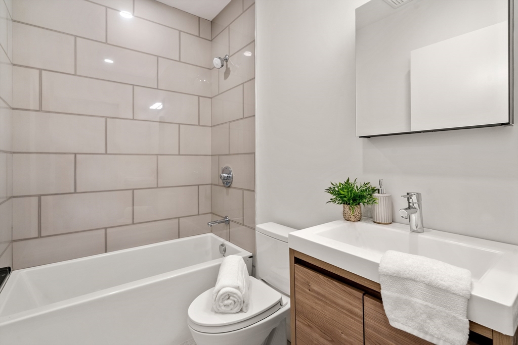 191 Condor Street, Unit 6 Boston, MA 02128 - Photo 12 of 14 a bathroom with a sink a toilet and bathtub