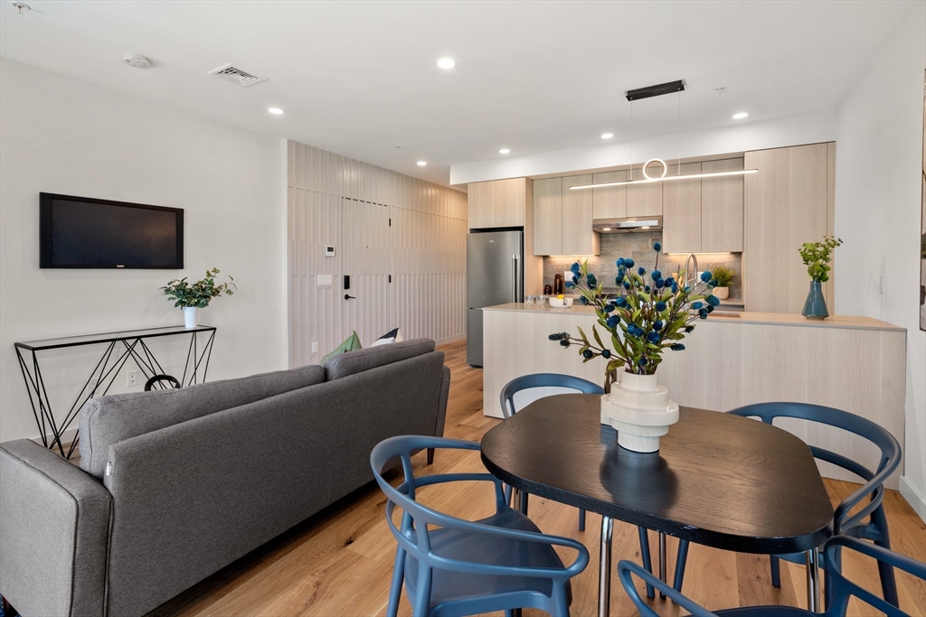 191 Condor Street, Unit 6 Boston, MA 02128 - Photo 2 of 14 a living room with furniture kitchen and a potted plant