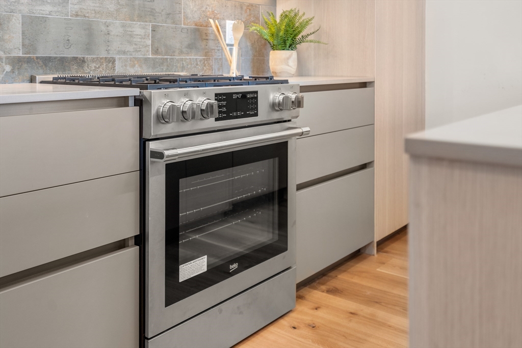 191 Condor Street, Unit 6 Boston, MA 02128 - Photo 3 of 14 a stove top oven sitting inside of a kitchen