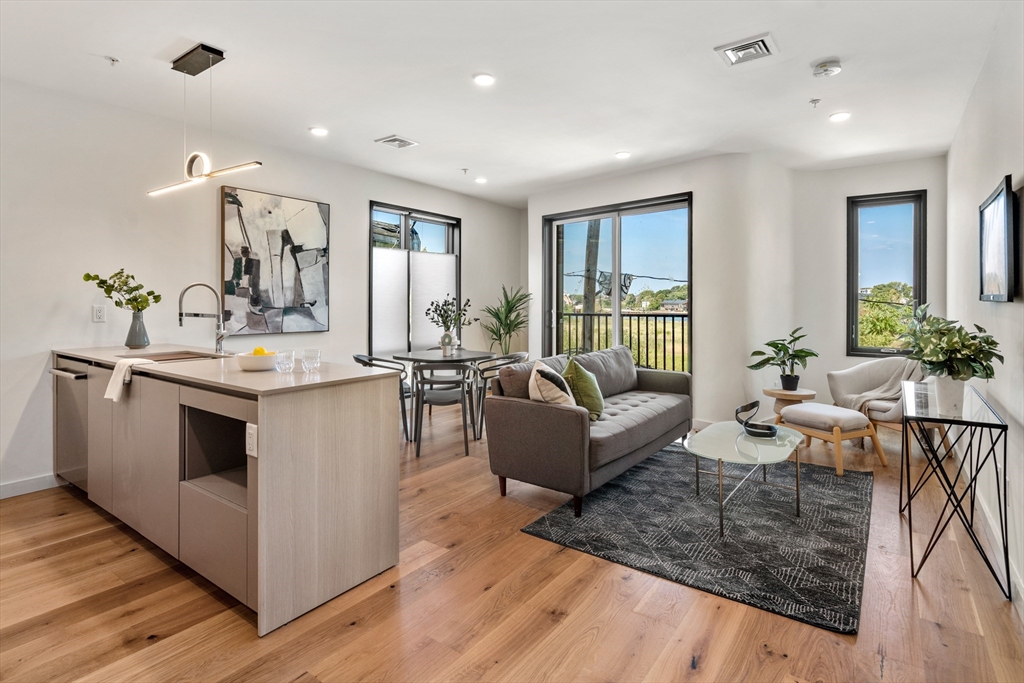 191 Condor Street, Unit 6 Boston, MA 02128 - Photo 4 of 14 a living room with furniture and a large window
