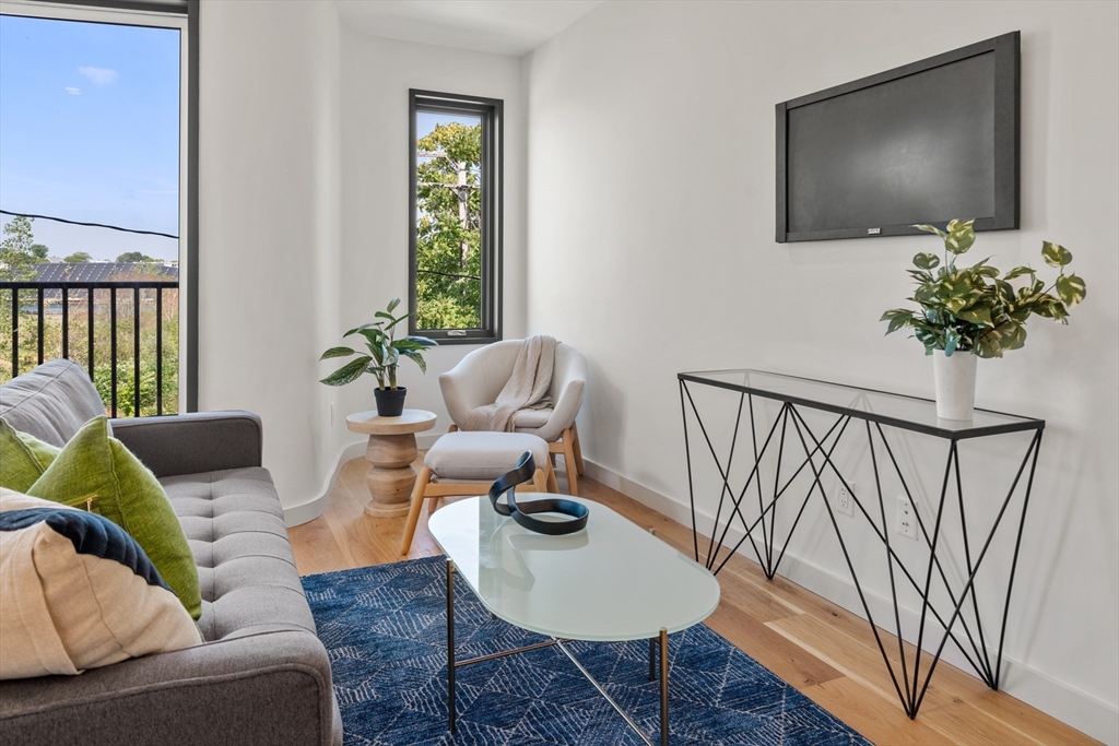 191 Condor Street, Unit 6 Boston, MA 02128 - Photo 5 of 14 a living room with furniture and a flat screen tv