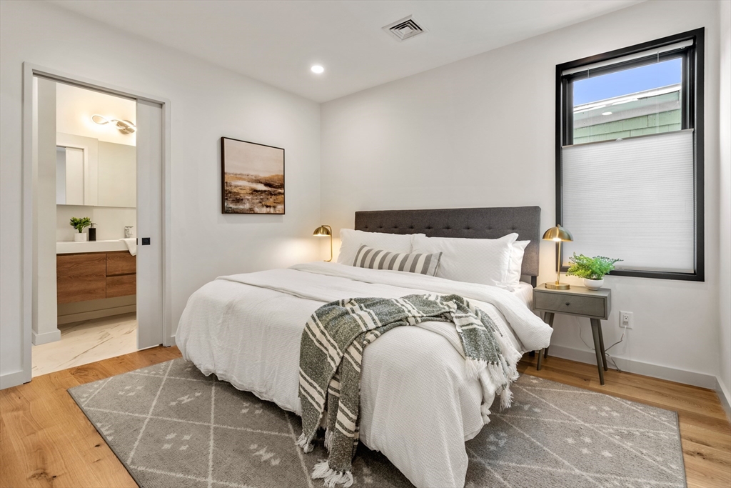 191 Condor Street, Unit 6 Boston, MA 02128 - Photo 8 of 14 a bedroom with a bed and a lamp on dresser