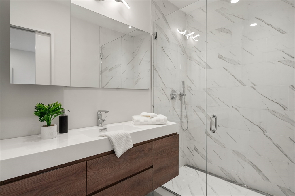 191 Condor Street, Unit 6 Boston, MA 02128 - Photo 9 of 14 a bathroom with a sink and a mirror