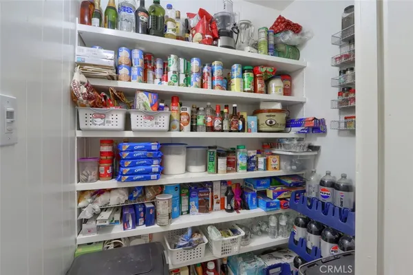 a room with a book shelf and a shelf with books