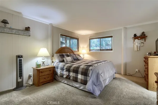 a spacious bedroom with a bed and a window
