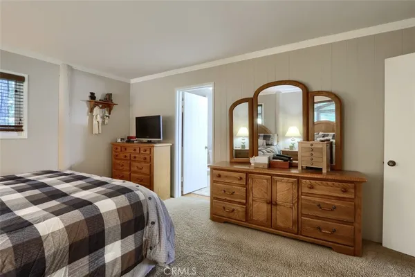 a bedroom with a bed and flat screen tv