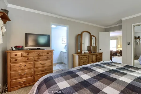 a bedroom with a bed and a flat screen tv in it