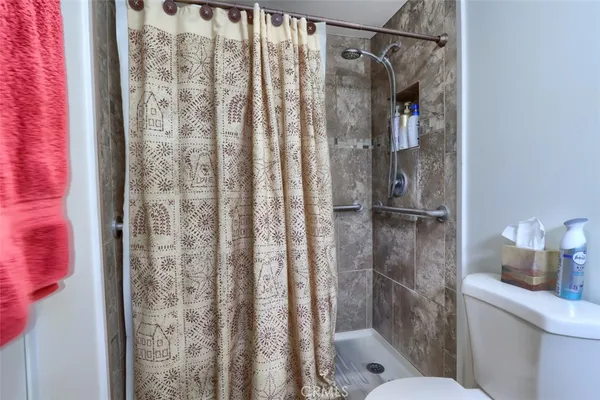 a bathroom with a shower curtain and a toilet