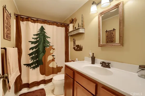 a bathroom with a sink and mirror with toilet