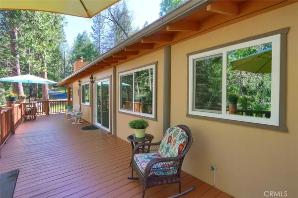 a view of a house with backyard sitting area and garden