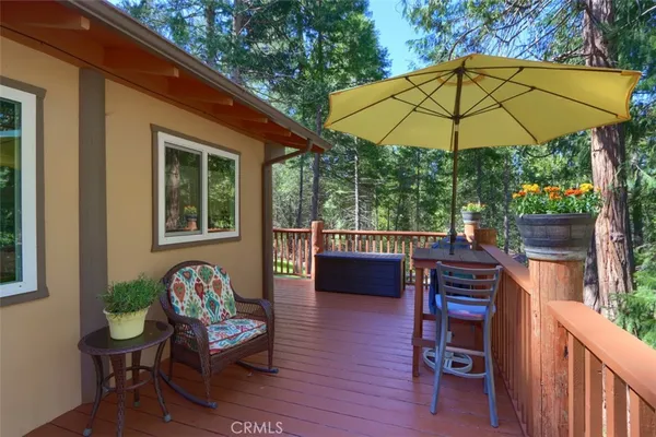 a view of a deck with furniture and a backyard