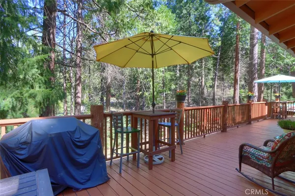a view of a patio with furniture and table under an umbrella