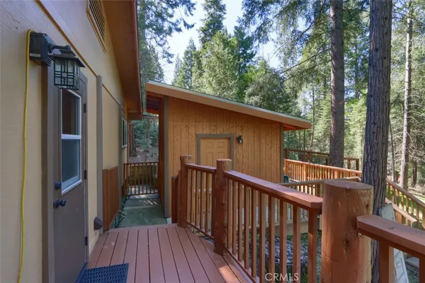 a view of a balcony with wooden floor and fence