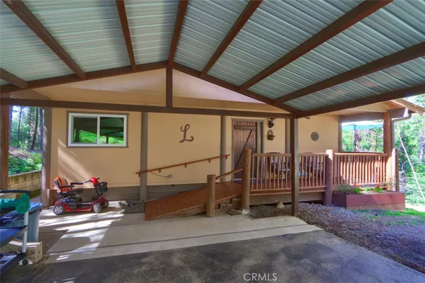a view of a porch with furniture and floor to ceiling window