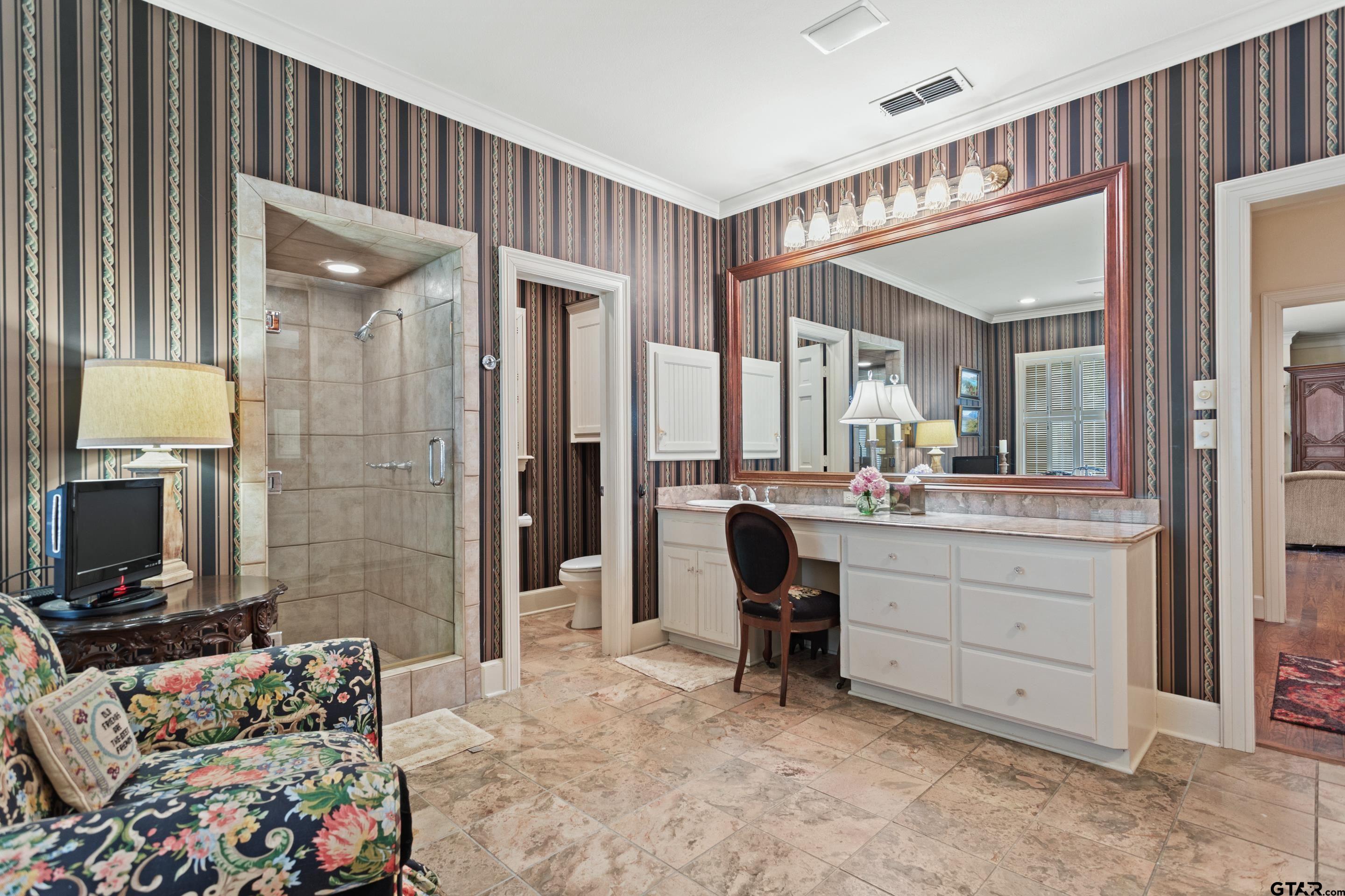 2631 Old Bullard Road Tyler, TX 75701 - Photo 23 of 43 a bedroom with a bed and a mirror