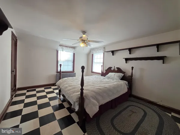 a bedroom with a bed and a lamp