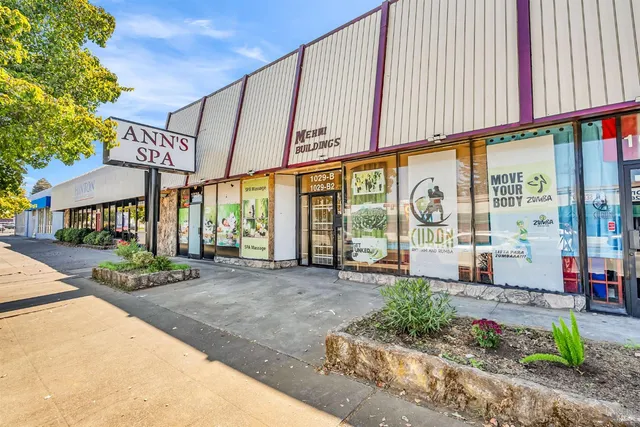 a front view of a building with a garden