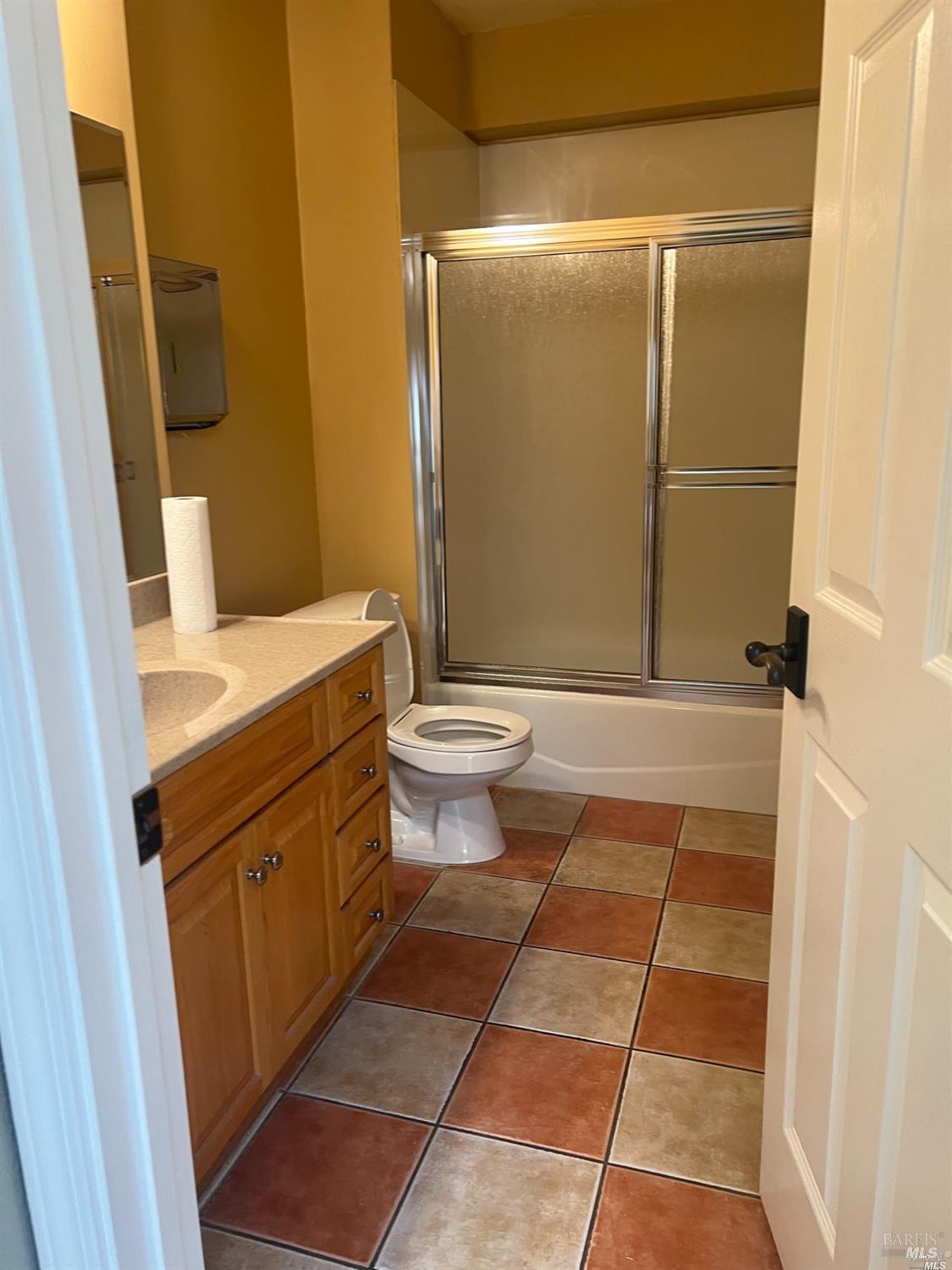 1029 Tennessee Street Vallejo, CA 94590 - Photo 3 of 19 a bathroom with a sink a toilet a mirror and shower