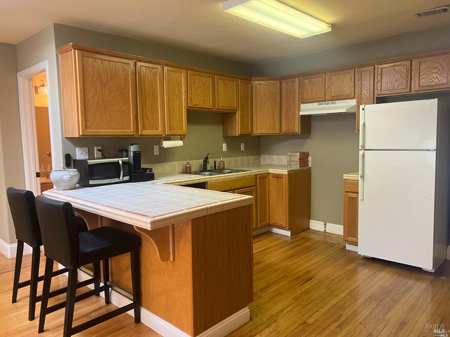 1029 Tennessee Street Vallejo, CA 94590 - Photo 5 of 19 a kitchen with a stove a refrigerator and a sink