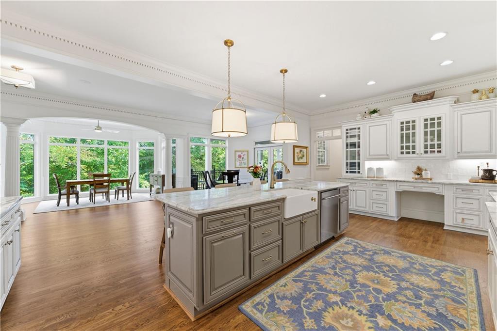 2918 Major Ridge Trail Duluth, GA 30097 - Photo 20 of 70 a large kitchen with kitchen island a large center island and a wooden floor