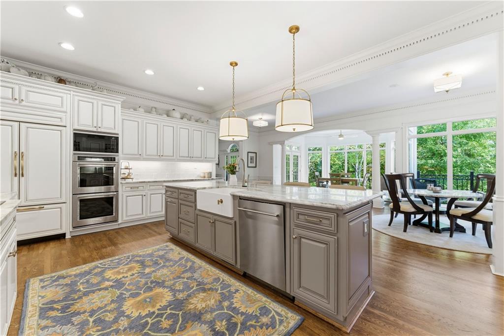 2918 Major Ridge Trail Duluth, GA 30097 - Photo 21 of 70 a kitchen with stainless steel appliances granite countertop a stove a sink a microwave a center island and furniture