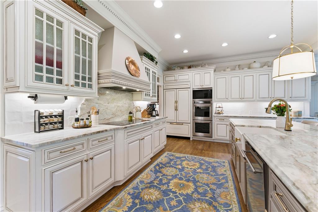 2918 Major Ridge Trail Duluth, GA 30097 - Photo 23 of 70 a kitchen with stainless steel appliances granite countertop a sink and cabinets