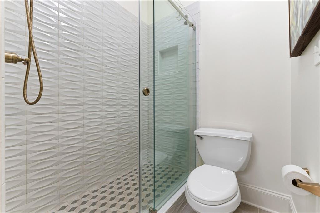 2918 Major Ridge Trail Duluth, GA 30097 - Photo 30 of 70 a white toilet sitting next to a bathroom sink