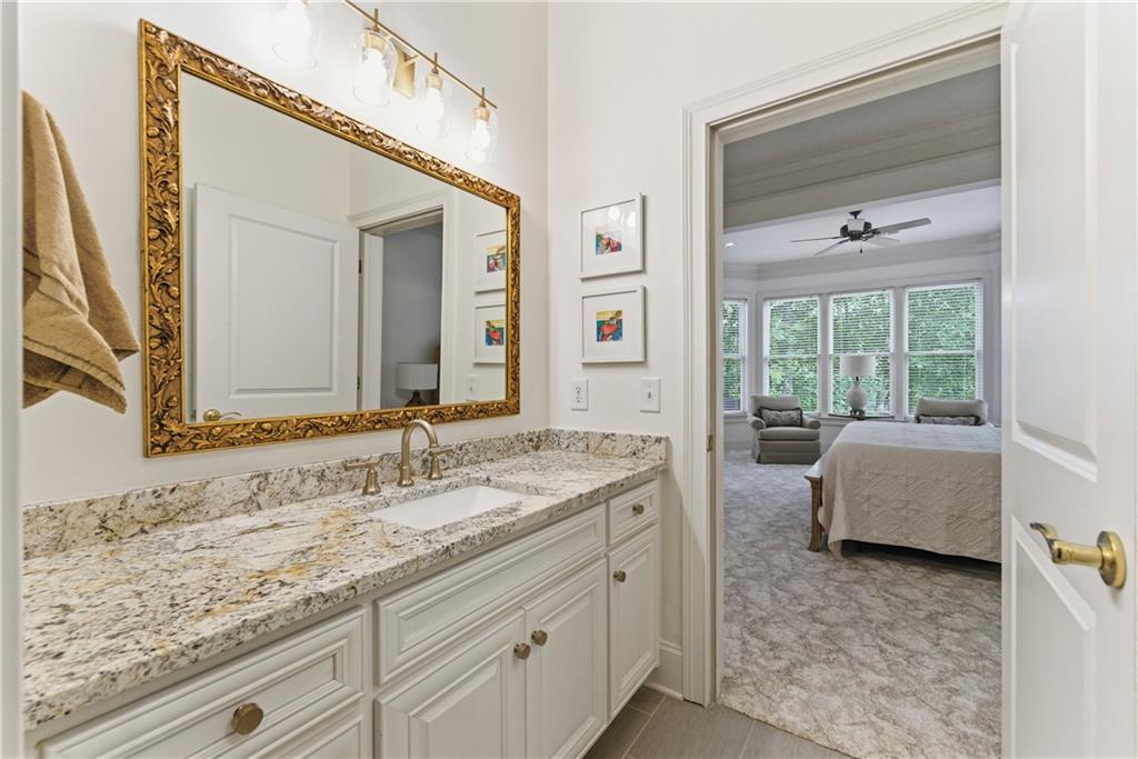 2918 Major Ridge Trail Duluth, GA 30097 - Photo 31 of 70 a bathroom with a granite countertop sink and a mirror