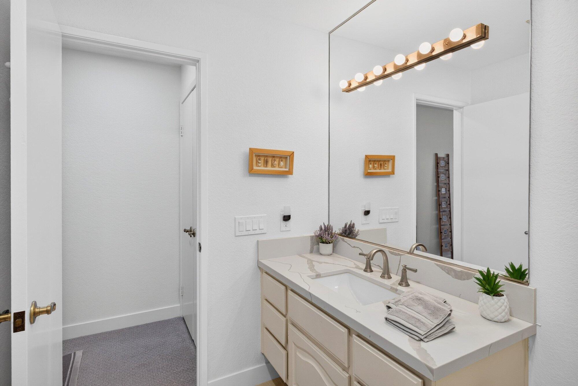 500 East Amado Road, Unit 313 Palm Springs, CA 92262 - Photo 18 of 32 a bathroom with a sink vanity and a mirror