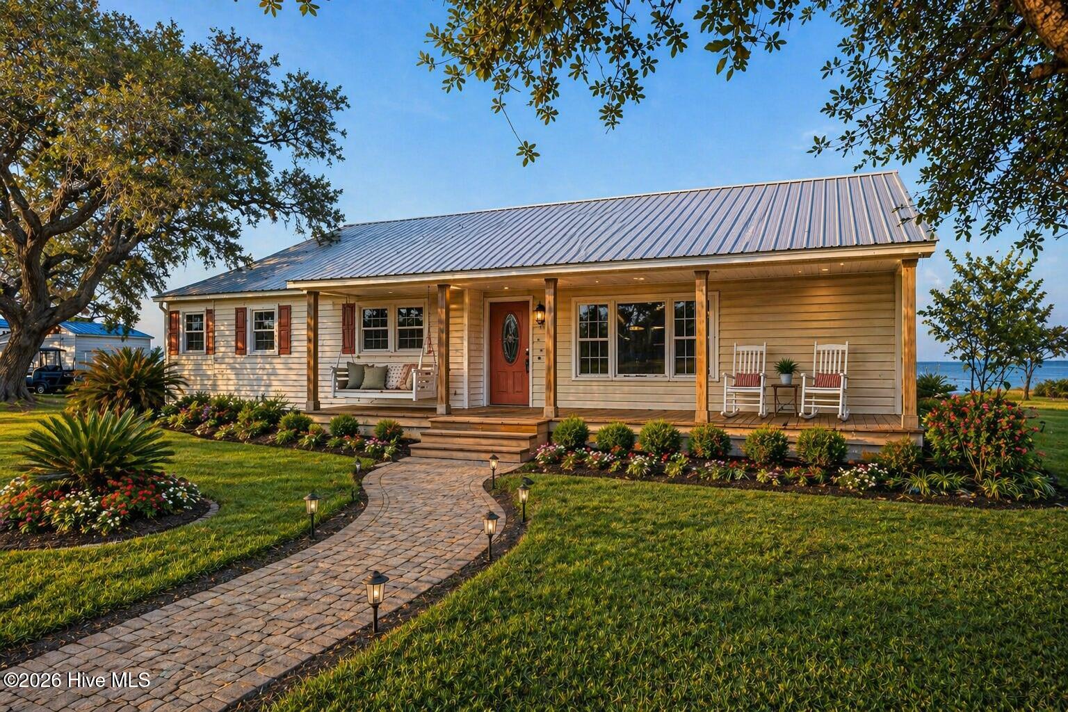 2472 Cedar Island Road Cedar Island, NC 28520 - Photo 30 of 33 AI-enhanced/virtually staged exterior image for visualization purposes only. Property condition differs; landscaping shown is not current.