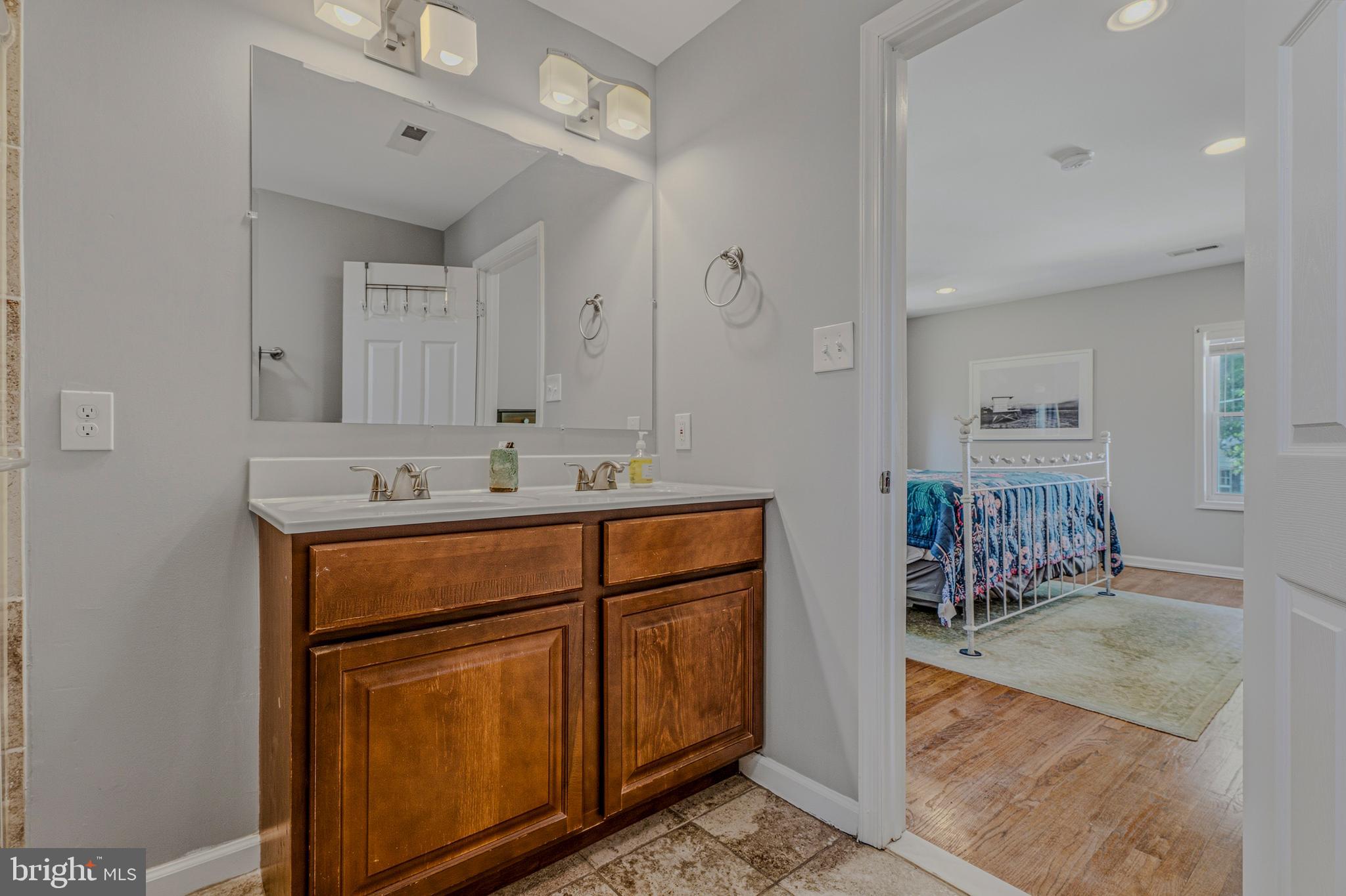 506 Brook Road Baltimore, MD 21286 - Photo 22 of 56 a bathroom with a sink double vanity and a mirror