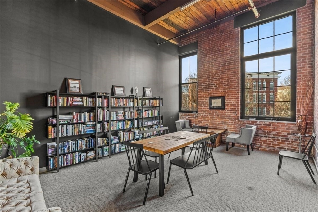 a view of a patio with a table and chairs and potted plants