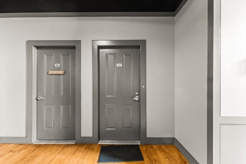 685 Social Street, Unit 215 Woonsocket, RI 02895 - Photo 17 of 40 a view of a livingroom with wooden floor and cabinet