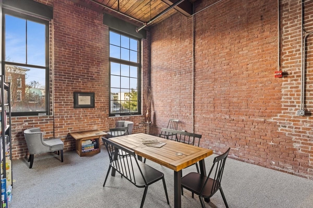 685 Social Street, Unit 215 Woonsocket, RI 02895 - Photo 18 of 40 a outdoor dining space with furniture and window
