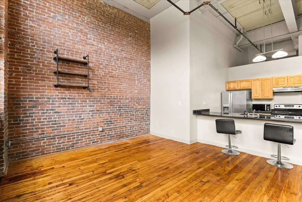 685 Social Street, Unit 215 Woonsocket, RI 02895 - Photo 29 of 40 a bedroom with a bed and a view of bathroom